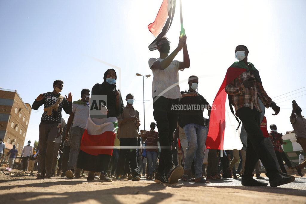 Marwan Ali Protesters gather during a demonstration, in Khartoum, Sudan, Saturday, Dec. 19, 2020. Protests in Sudan’s capital and across the country are demanding a faster pace to democratic reforms, in demonstrations that are marking the two-year anniversary of the uprising that led to the military’s ouster of strongman Omar al-Bashir. (AP Photo/Marwan Ali)