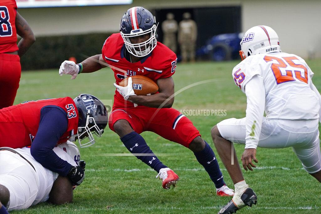 Rogelio V. Solis Jackson State running back Tyson Alexander (25) attempts to run from Edward Waters defensive back Martavius Davis (25) during the second half of an NCAA college football game in Jackson, Miss., Sunday, Feb. 21, 2021. (AP Photo/Rogelio V. Solis)