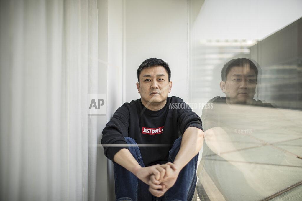Uncredited U.S. citizen Daniel Hsu poses for a portrait in the apartment he has been renting in Shanghai, China on Monday, April 13, 2020. Friends offered Hsu jobs or money to start a restaurant in Shanghai. But he always declined, worried he’d get them in trouble. He couldn’t work legally because he had a U.S. passport with an expired visa and the Anhui authorities wouldn’t give him paperwork needed to get a new one. (AP Photo)