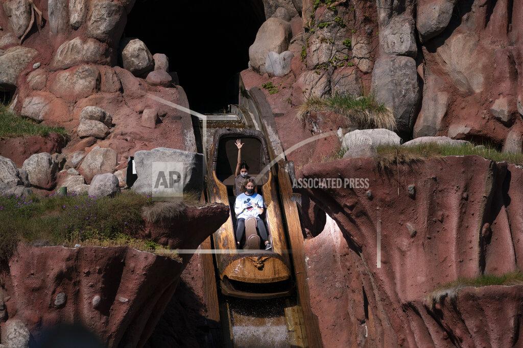 Jae C. Hong Guests ride the Splash Mountain attraction at Disneyland in Anaheim, Calif., Friday, April 30, 2021. The iconic theme park in Southern California that was closed under the state's strict virus rules swung open its gates Friday and some visitors came in cheering and screaming with happiness. (AP Photo/Jae C. Hong)