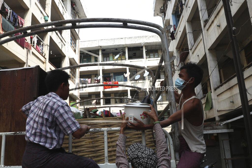 Uncredited State railway employees load their belongings after being evicted from their home Saturday, March 20, 2021, in Mandalay, Myanmar. State railway workers in Mandalay have been threatened with eviction to force them to end their support for the Civil Disobedience Movement (CDM) against military rule. (AP Photo)
