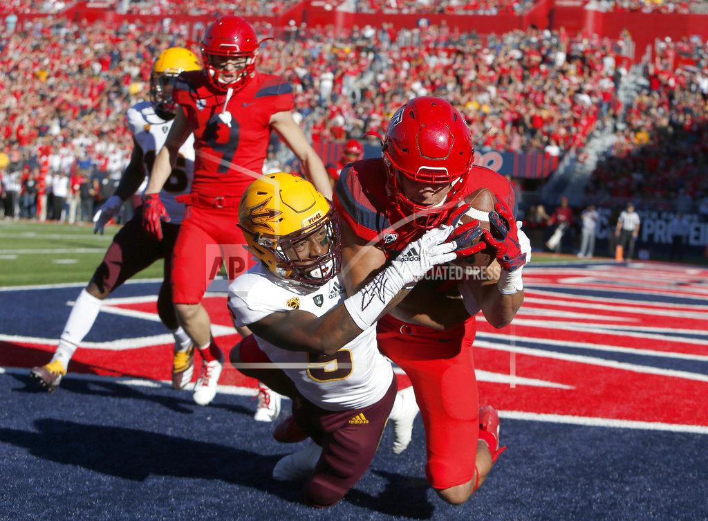 Rick Scuteri Arizona wide receiver Shawn Poindexter, right, catches a touchdown pass while being defended by Arizona safety Christian Young (5) in the first half during an NCAA college football game, Saturday, Nov. 24, 2018, in Tucson, Ariz. (AP Photo/Rick Scuteri)