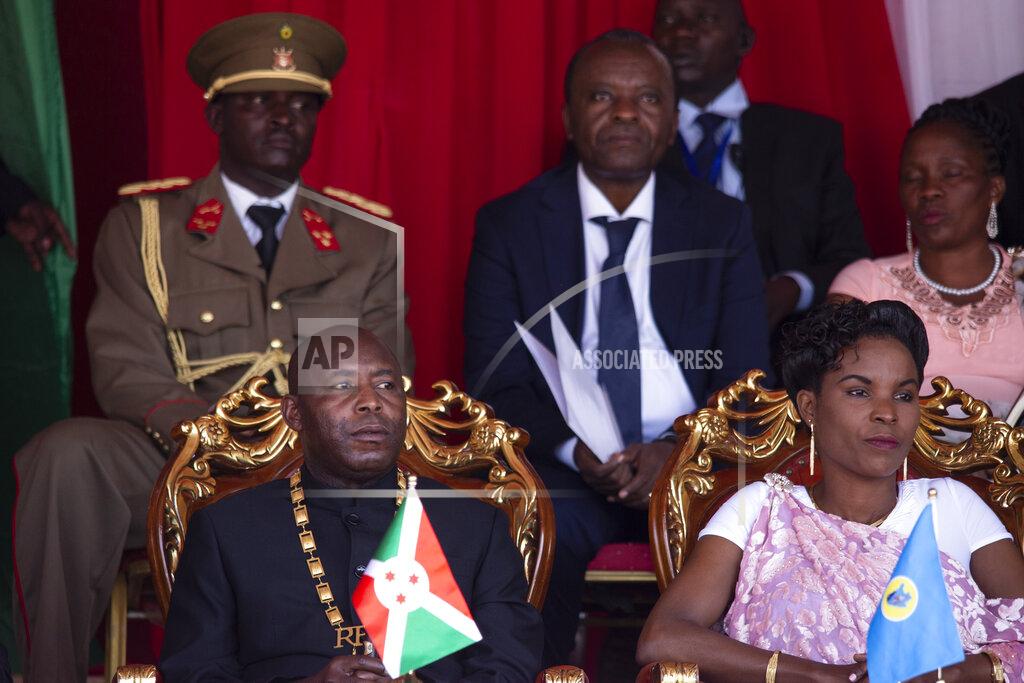 Burundi's President Evariste Ndayishimiye, left, and his wife Angeline Ndayubaha, right, attend his inauguration in Gitega, Burundi, Thursday, June 18, 2020. President Evariste Ndayishimiye took power two months early after the abrupt death of his predecessor Pierre Nkurunziza. (AP Photo/Berthier Mugiraneza)