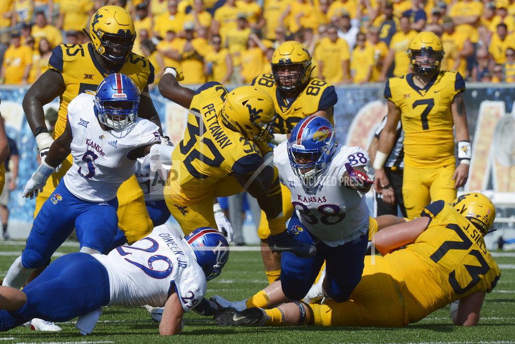 Craig Hudson West Virginia running back Martell Pettaway (32) is brought down by Kansas linebacker Joe Dineen Jr. (29) during the second half of an NCAA college football game in Morgantown, W. Va., Saturday Oct. 6, 2018. (AP Photo/Craig Hudson)
