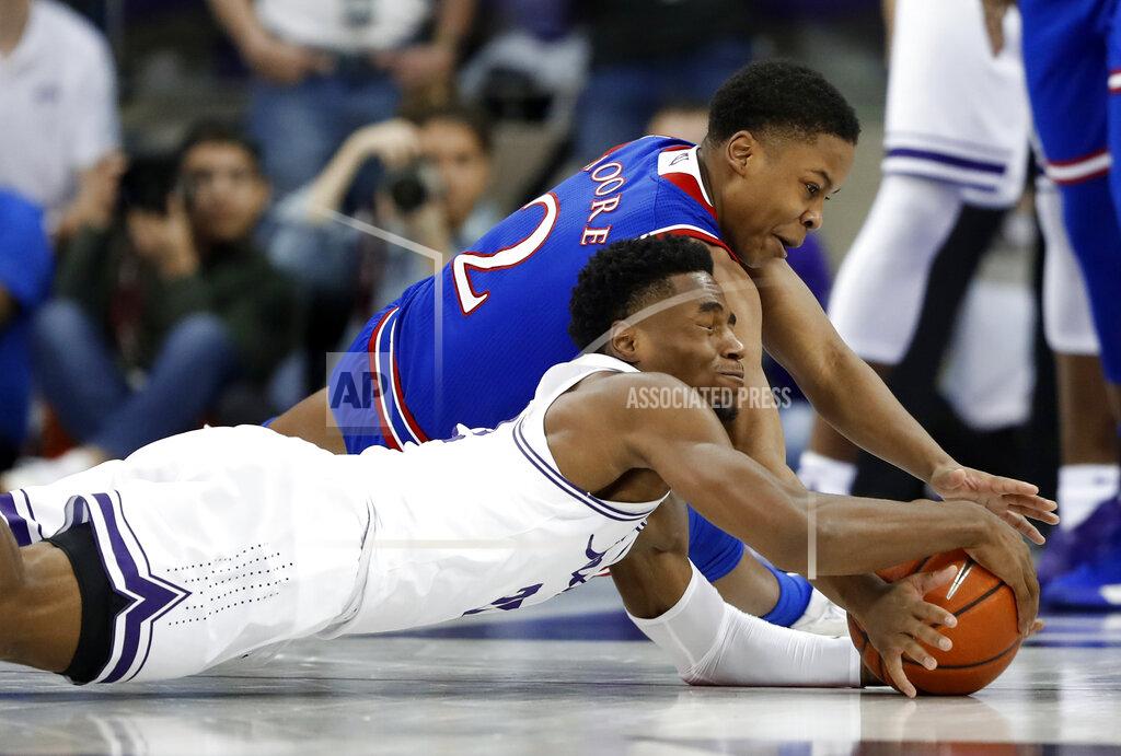 Tony Gutierrez TCU guard RJ Nembhard, front, and Kansas guard Charlie Moore (2) wrestle on the floor for control of a loose ball in the first half of an NCAA college basketball game in Fort Worth, Texas, Monday, Feb. 11, 2019. (AP Photo/Tony Gutierrez)