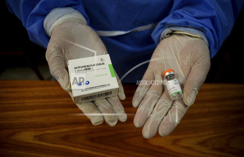 Muhammad Sajjad A paramedic holds Sinopharm coronavirus vaccines at a vaccination center, in Peshawar, Pakistan, Wednesday, Feb. 3, 2021. Pakistani authorities started vaccinating frontline health workers on Wednesday amid a steady decline in confirmed cases and fatalities, days after Pakistan received half a million doses of the Sinopharm vaccine donated by China. (AP Photo/Muhammad Sajjad)