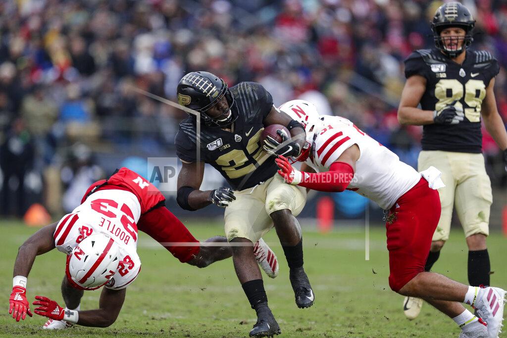 Michael Conroy Purdue running back King Doerue (22) is tackled by Nebraska cornerback Dicaprio Bootle (23) and linebacker Collin Miller (31) during the first half of an NCAA college football game in West Lafayette, Ind., Saturday, Nov. 2, 2019. (AP Photo/Michael Conroy)