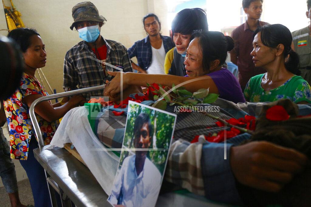 Uncredited Family members mourn over the death of Aung Myo Thant during his funeral in Yangon, Myanmar, Tuesday, March 30, 2021. Aung Myo Thant was killed Monday during a clash with security forces at a protest against the military's coup that ousted the government of Aung San Suu Kyi. (AP Photo)