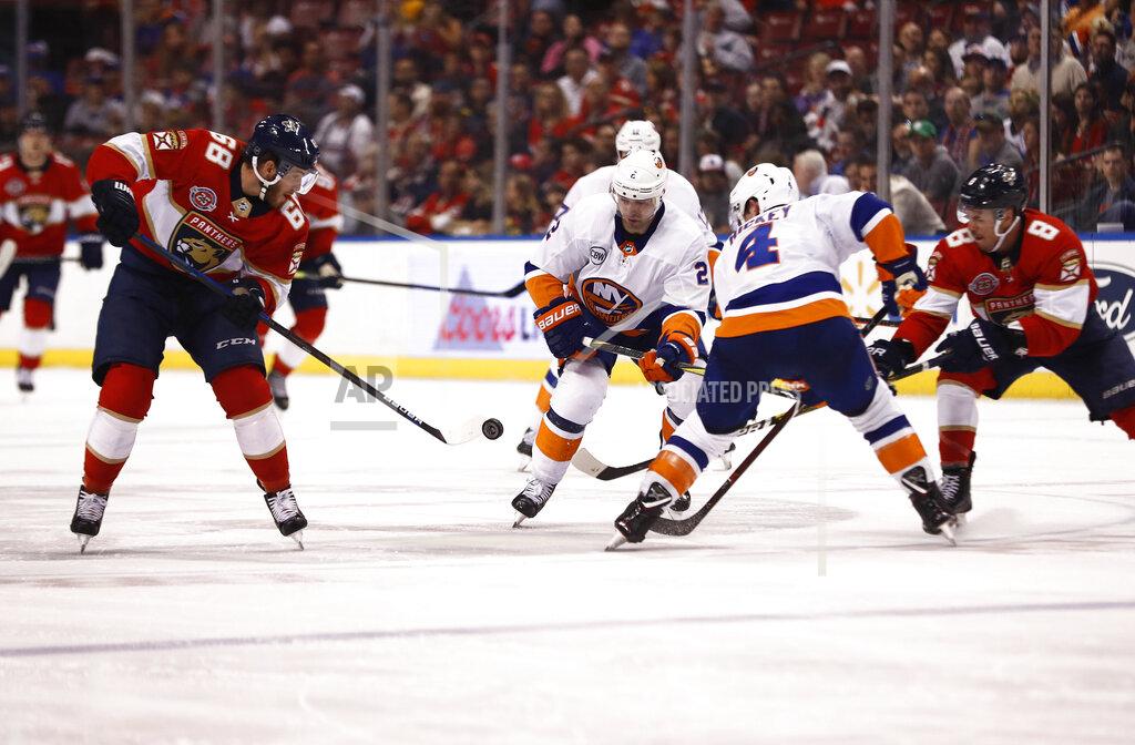 Brynn Anderson Florida Panthers left wing Mike Hoffman (68) and New York Islanders defenseman Nick Leddy (2) fight for the puck during the second period of an NHL hockey game on Thursday, April 4, 2019, in Sunrise, Fla. (AP Photo/Brynn Anderson)