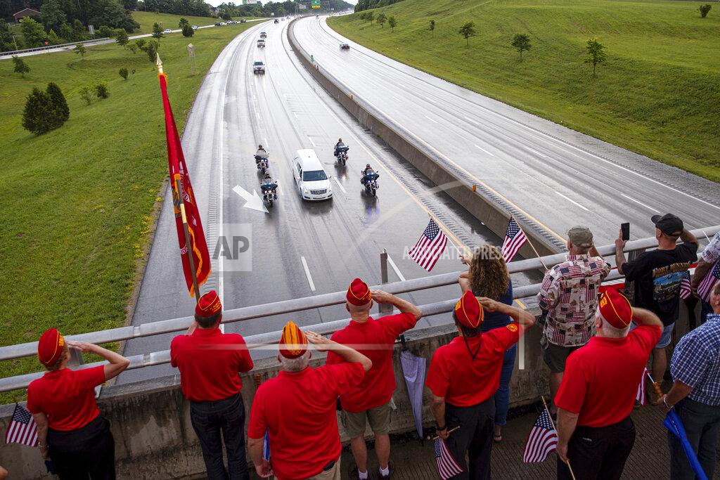 Sholten Singer Marine Corps League veterans salute as the funeral procession for Medal of Honor recipient Hershel "Woody" Williams moves along Interstate 64 on Saturday, July 2, 2022, in Teays Valley, W.Va. (Sholten Singer/The Herald-Dispatch via AP)