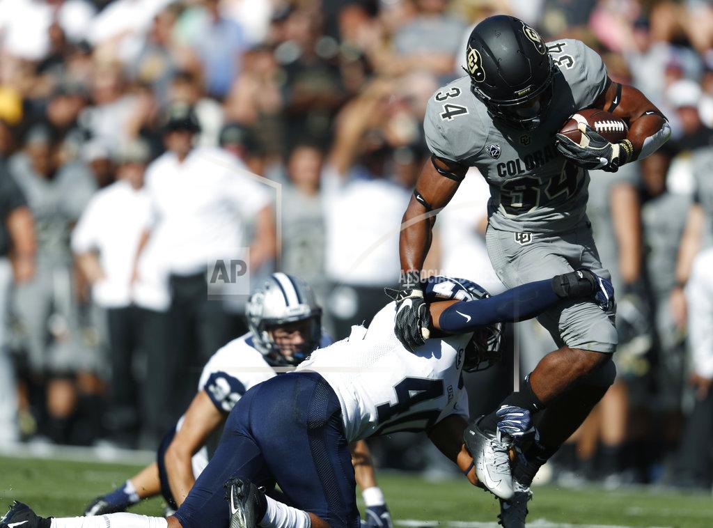 David Zalubowski Colorado running back Travon McMillian, right, pulls away from New Hampshire safety Pop Lacey for a short gain in the first half of an NCAA college football game Saturday, Sept. 15, 2018, in Boulder, Colo. (AP Photo/David Zalubowski)