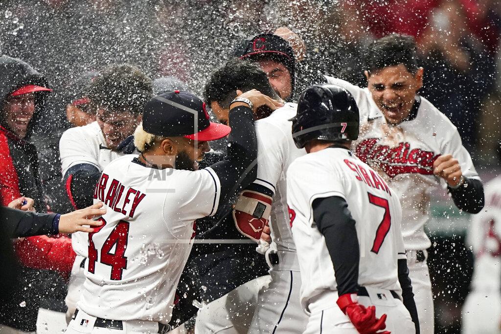 Tony Dejak Cleveland Indians' Oscar Mercado, center, is mobbed by teammates after hitting a two-run home run in the seventh inning in the second baseball game of a doubleheader against the Chicago White Sox, Thursday, Sept. 23, 2021, in Cleveland. The Indians won 5-3. (AP Photo/Tony Dejak)
