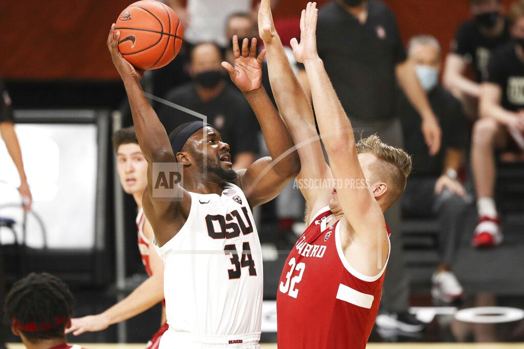 Amanda Loman Oregon State's Rodrigue Andela (34) shoots over Stanford's Lukas Kisunas (32) during the first half of an NCAA college basketball game in Corvallis, Ore., Monday, Jan. 4, 2021. (AP Photo/Amanda Loman)