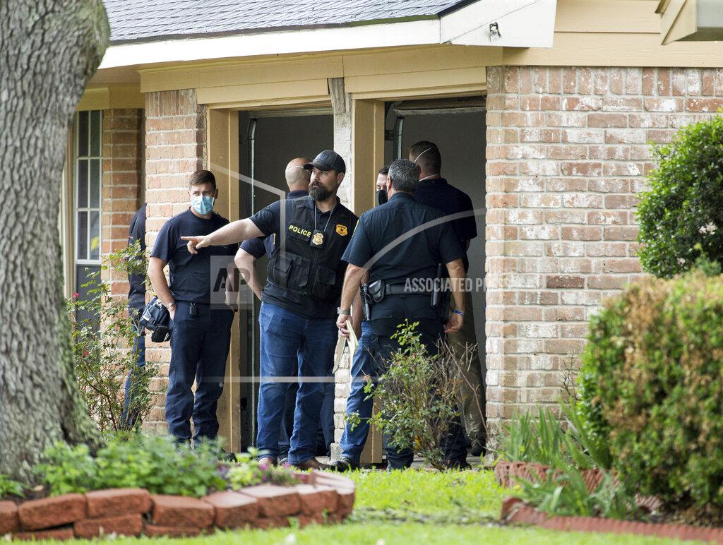 Godofredo A. Vásquez Law enforcement officials investigate the site of a human smuggling case, where more than 90 undocumented immigrants were found inside a home on the 12200 block of Chessington Drive on Friday, April 30, 2021, in Houston. A Houston Police officials said the case will be handled by federal authorities. ( Godofredo A. Vásquez/Houston Chronicle via AP)