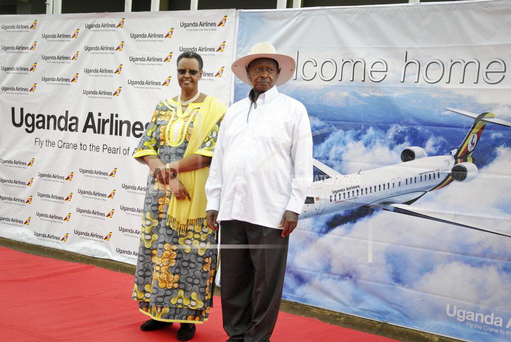 FILE - In this Tuesday, April 23, 2019 file photo, Uganda's President Yoweri Museveni and First Lady Janet Museveni attend a ceremony to mark the arrival of two CRJ-900 jets from Canadian aerospace company Bombardier for Uganda's national carrier Uganda Airlines, at the airport in Entebbe, Uganda. Questions are swirling in Africa and elsewhere over the financial wisdom of sustaining prestige carriers that have a tiny share of an aviation market that sees no recovery in sight as sub-Saharan Africa faces its first recession in a quarter-century amid coronavirus-related travel restrictions. (AP Photo/Ronald Kabuubi, File)