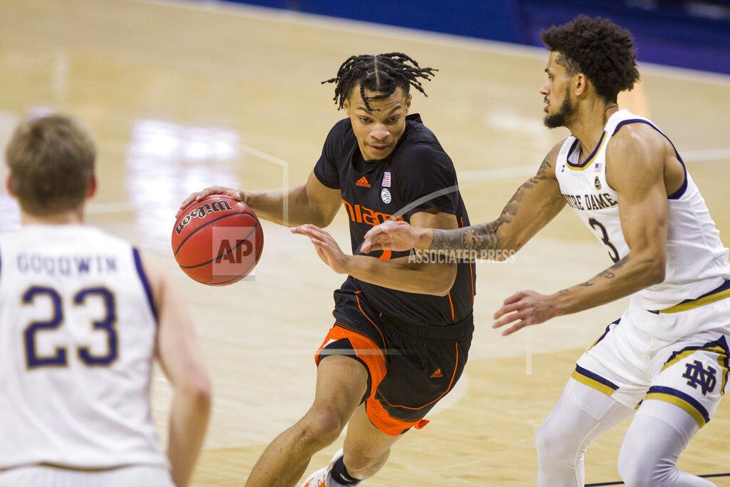 Robert Franklin Miami's Isaiah Wong, center, drives between Notre Dame's Dane Goodwin (23) and Prentiss Hubb (3) during the first half of an NCAA college basketball game Sunday, Feb. 14, 2021, in South Bend, Ind. (AP Photo/Robert Franklin)
