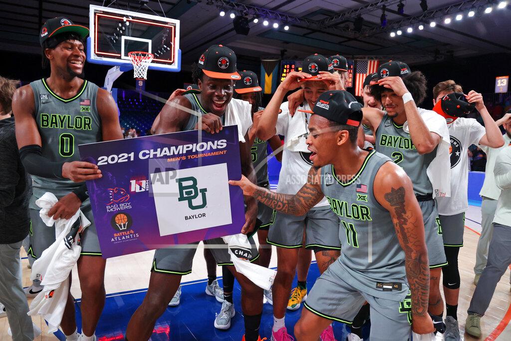 Tim Aylen In this photo provided by Bahamas Visual Services, Baylor guard James Akinjo (11) celebrates with teammates after defeating Michigan State in an NCAA college basketball game at Paradise Island, Bahamas, Friday, Nov. 26, 2021. (Tim Aylen/Bahamas Visual Services via AP)