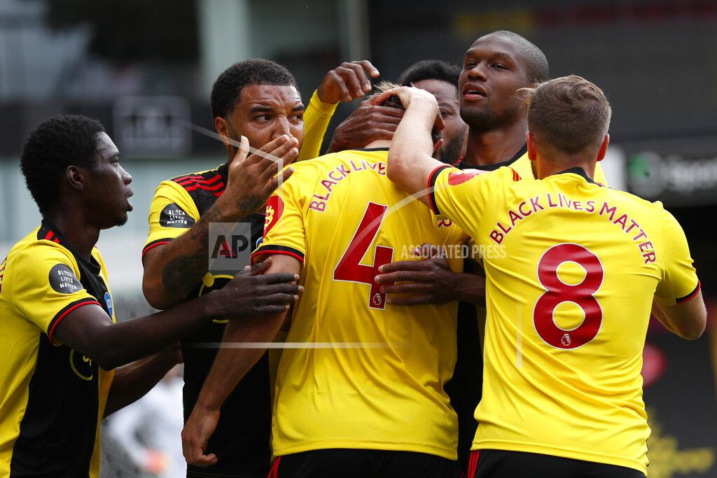 Alastair Grant Watford's Craig Dawson (4), celebrates with teammates after scoring his side's opening goal during the English Premier League soccer match between Watford and Leicester City at the Vicarage Road Stadium in Watford, England, Saturday, June 20, 2020. (AP Photo/Alastair Grant, POOL)