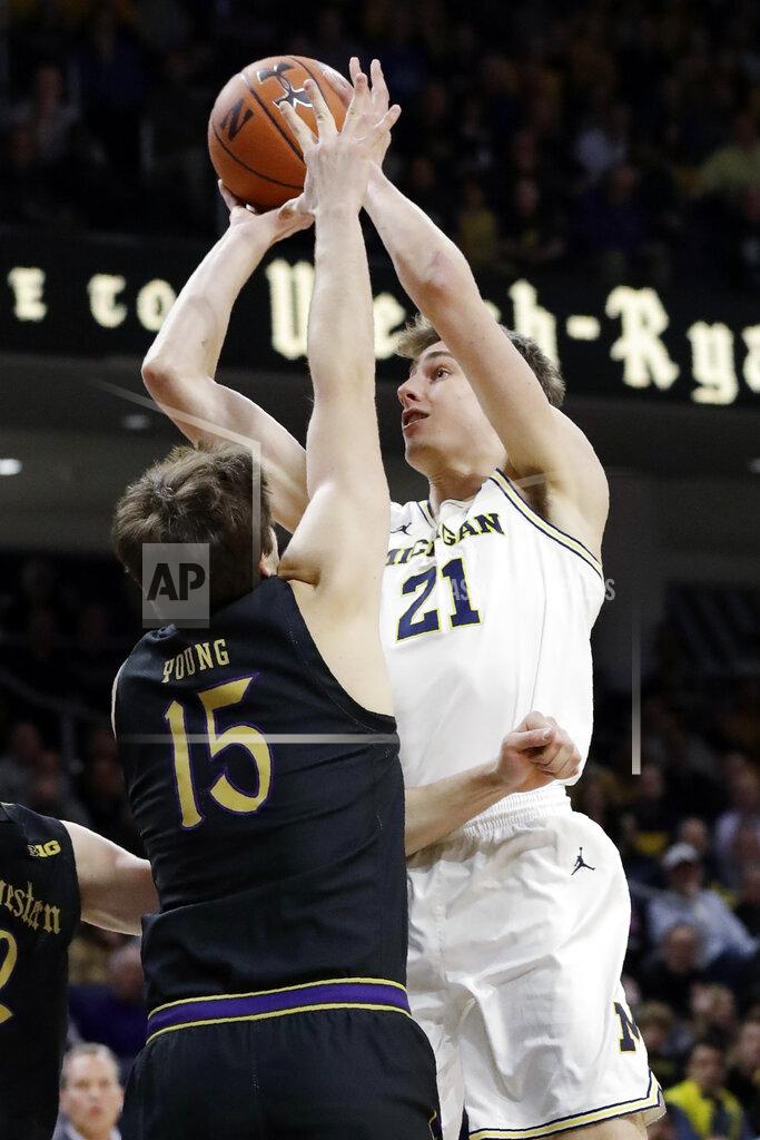 Nam Y. Huh Michigan guard Franz Wagner, right, shoots against Northwestern center Ryan Young during the first half of an NCAA college basketball game in Evanston, Ill., Wednesday, Feb. 12, 2020. (AP Photo/Nam Y. Huh)