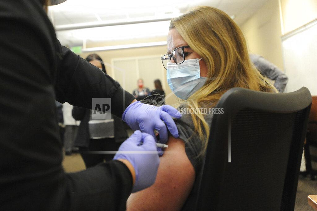 John Roark FILE - In this Dec. 14, 2020, file photo, Michelle Rumsey receives one of the first inoculations for COVID-19 in Idaho from Amy Gamett, EIPH clinical services administrator, at Madison Memorial Hospital in Rexburg, Idaho. Idaho officials have released a rough timeline for when residents can expect it to be their turn to get the coronavirus vaccination. (John Roark/The Idaho Post-Register via AP, File)