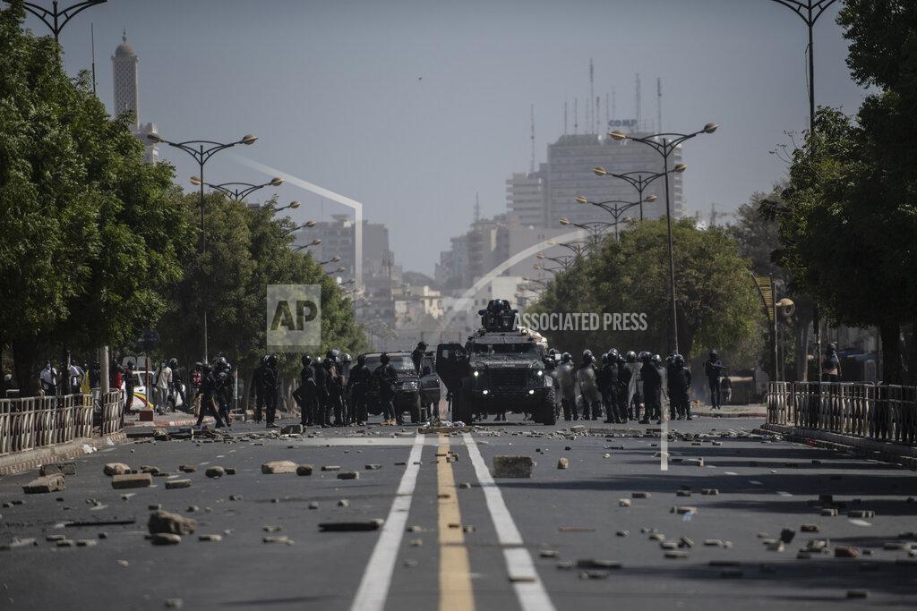 Sylvain Cherkaoui Riot police face supporters of opposition leader and former presidential candidate Ousmane Sonko in Dakar, Senegal, Monday, March 8, 2021. Senegalese authorities have freed opposition leader Ousmane Sonko while he awaits trial on charges of rape and making death threats. The case already has sparked deadly protests threatening to erode Senegal's reputation as one of West Africa’s most stable democracies. (AP Photo/Sylvain Cherkaoui)