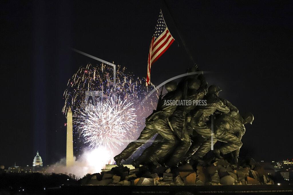 Shafkat Anowar Fireworks explode over the Washington Monument with the Marine Corps War Memorial in the foreground, Wednesday, Jan. 20, 2021, in Arlington, Va., as part of the festivities after President Joe Biden was inaugurated as the 46th president of the United States. (AP Photo/Shafkat Anowar)
