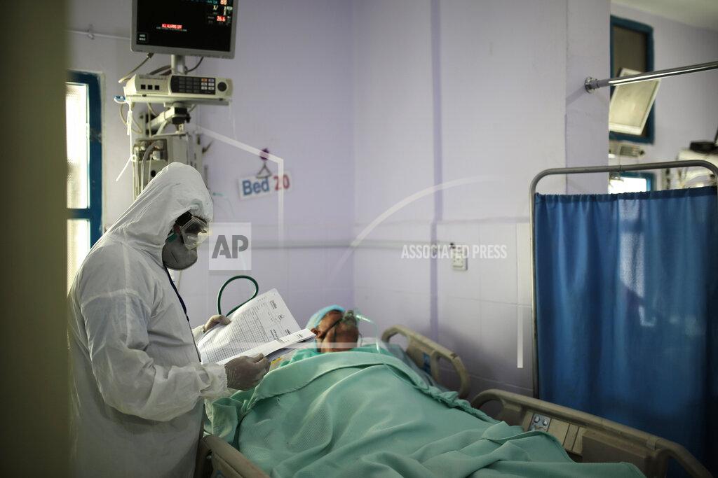 Hani Mohammed A medical worker wearing personal protective equipment takes care of a COVID-19 patient in an intensive care unit at a hospital in Sanaa, Yemen, Sunday, June 14, 2020. (AP Photo/Hani Mohammed)