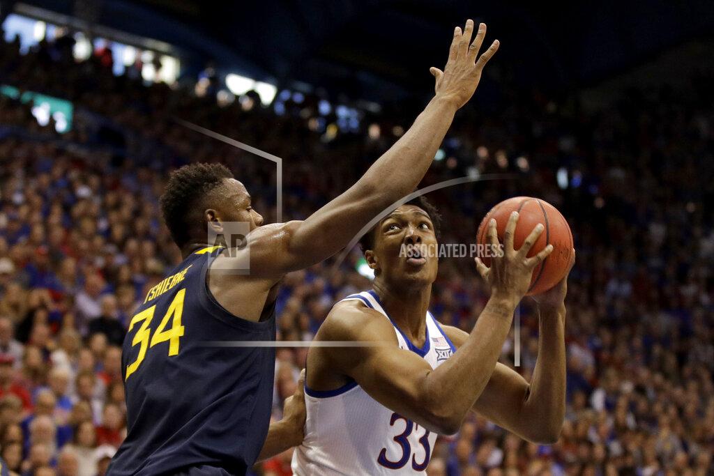 Charlie Riedel Kansas' David McCormack (33) shoots under pressure from West Virginia's Oscar Tshiebwe (34) during the first half of an NCAA college basketball game Saturday, Jan. 4, 2020, in Lawrence, Kan. (AP Photo/Charlie Riedel)