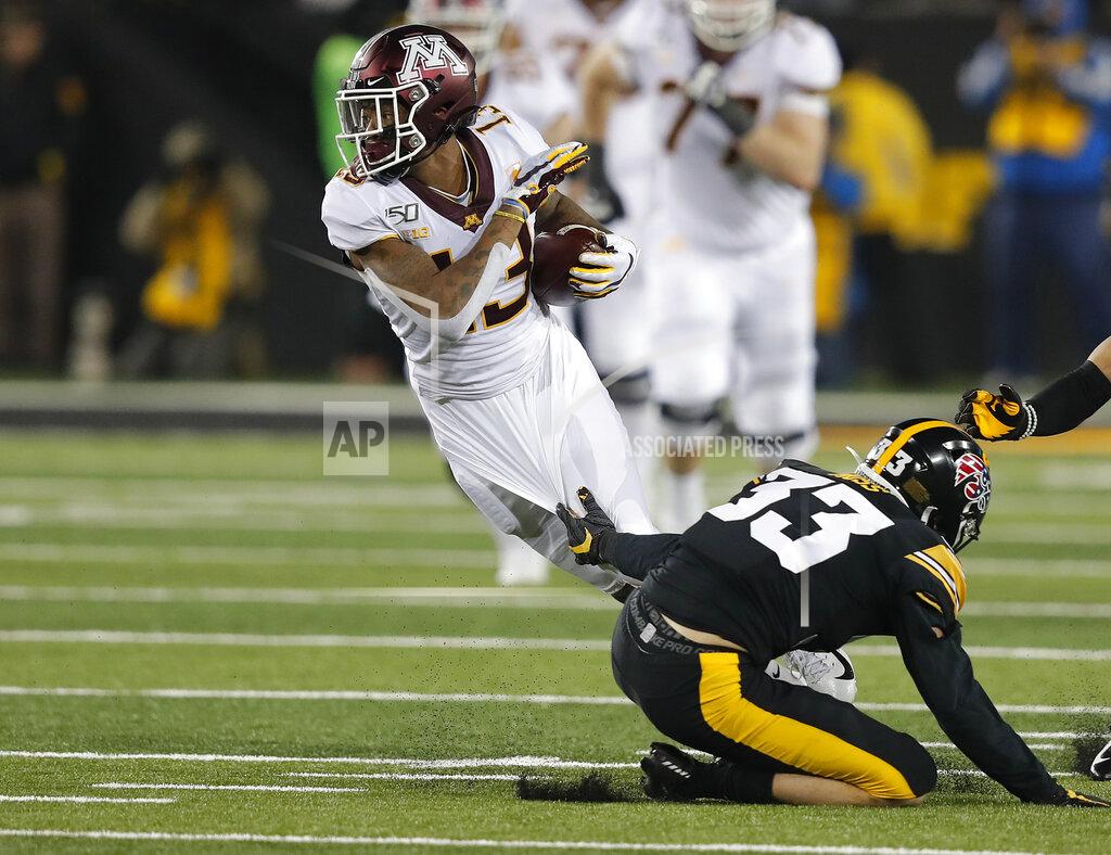 Matthew Putney Minnesota wide receiver Rashod Bateman, left, is tripped by Iowa defensive back Riley Moss while running the ball during the second half of an NCAA college football game, Saturday, Nov. 16, 2019, in Iowa City, Iowa. (AP Photo/Matthew Putney)
