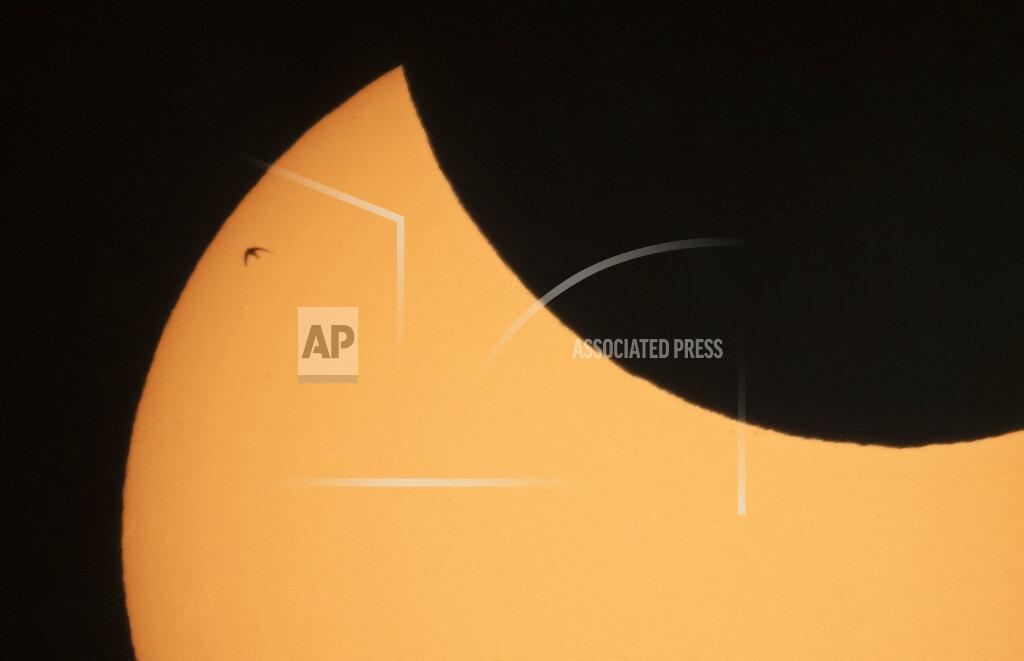 Dmitri Lovetsky A bird is silhouetted against the sun as the moon blocks part of the sun during a partial solar eclipse in St. Petersburg, Russia, Thursday, June 10, 2021. (AP Photo/Dmitri Lovetsky)
