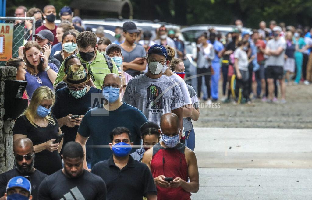 John Spink Voters wait in line before voting at the Park Tavern polling place in Atlanta on Tuesday, June 9, 2020. (John Spink/Atlanta Journal-Constitution via AP)