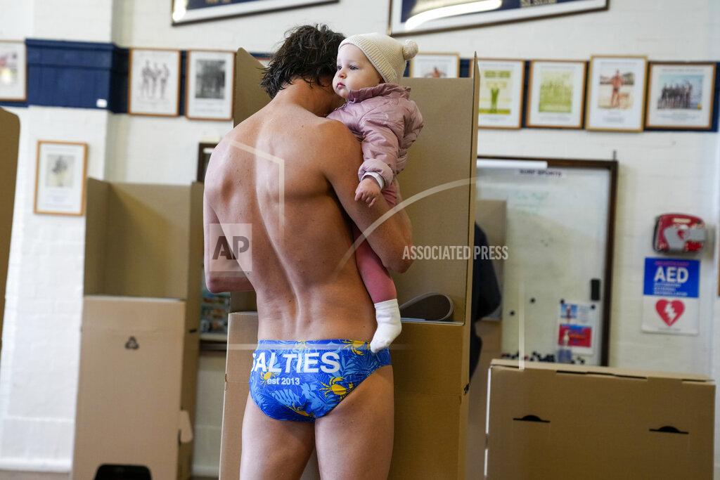 Mark Baker Jim Finn holds his eight-month-old daughter Allegra as he casts his vote at a polling booth in Sydney, Australia, Saturday, May 21, 2022. Australians go to the polls Saturday following a six-week election campaign that has focused on pandemic-fueled inflation, climate change and fears of a Chinese military outpost being established less than 1,200 miles off Australia's shore.(AP Photo/Mark Baker)