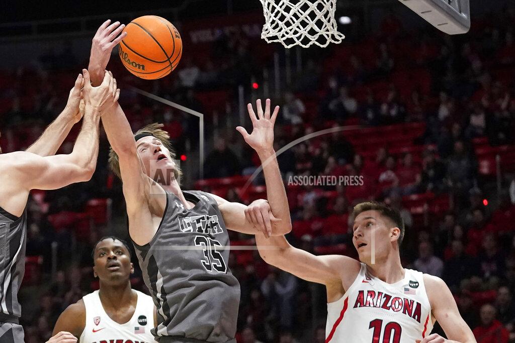 Rick Bowmer Utah center Branden Carlson (35) reaches for a rebound next to Arizona forward Azuolas Tubelis (10) during the first half during an NCAA college basketball game Thursday, Feb. 24, 2022, in Salt Lake City. (AP Photo/Rick Bowmer)