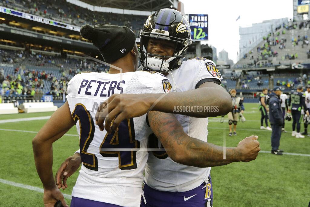 John Froschauer Baltimore Ravens quarterback Lamar Jackson, right, hugs cornerback Marcus Peters (24) after an NFL football game, Sunday, Oct. 20, 2019, in Seattle. (AP Photo/John Froschauer)