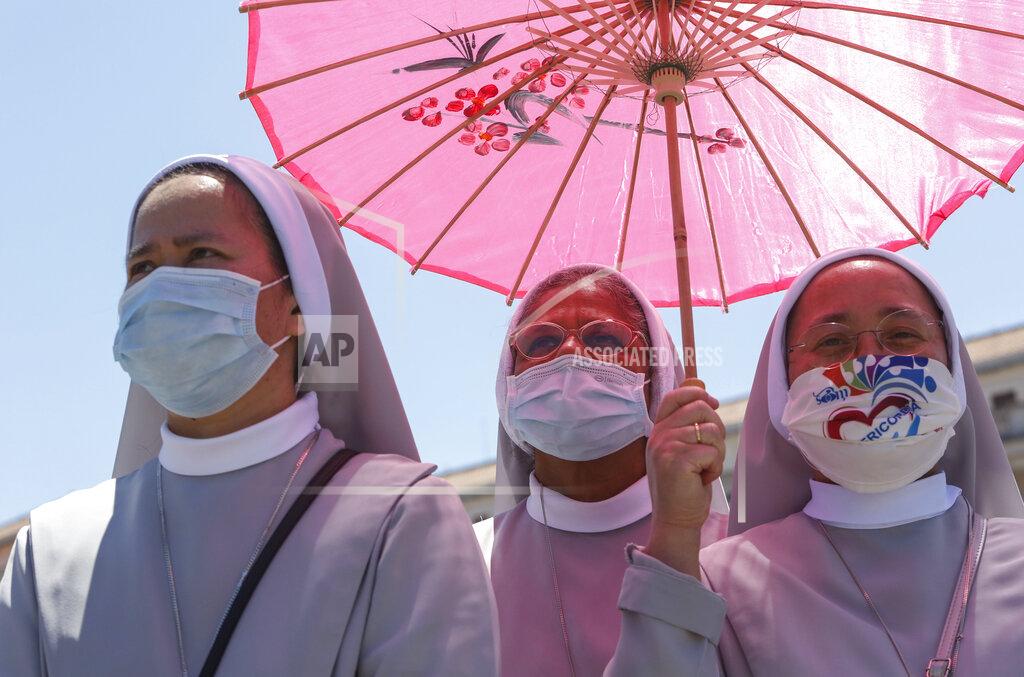 Riccardo De Luca Nuns wearing protective masks take shelter from the sun as they attend the Angelus prayer celebrated by Pope Francis from his studio window overlooking St. Peter's Square at the Vatican, Sunday, July 5, 2020. (AP Photo/Riccardo De Luca)