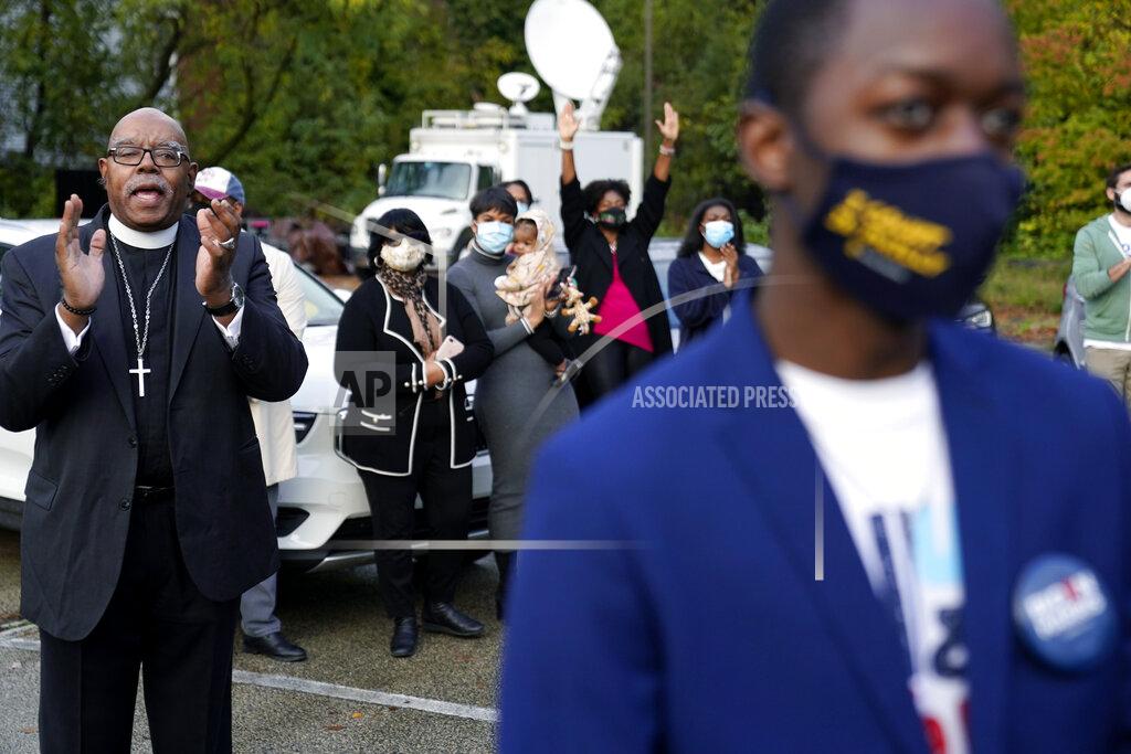 Supporters listen to Democratic presidential candidate former Vice President Joe Biden speak at a "Souls to the Polls" drive-in rally at Sharon Baptist Church, Sunday, Nov. 1, 2020, in Philadelphia. (AP Photo/Andrew Harnik)