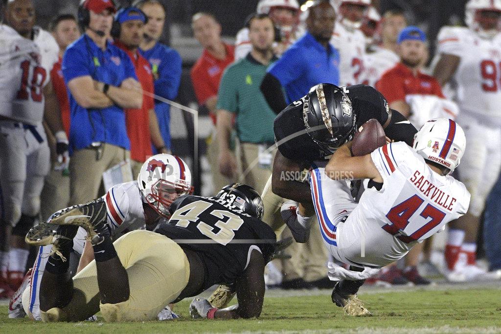 Phelan M. Ebenhack SMU punter Jamie Sackville (47) is stopped short of a first down by Central Florida defensive lineman Aaron Cochran (43) and defensive lineman Titus Davis on a fake punt play during the second half of an NCAA college football game Saturday, Oct. 6, 2018, in Orlando, Fla. UCF won 48-20. (AP Photo/Phelan M. Ebenhack)