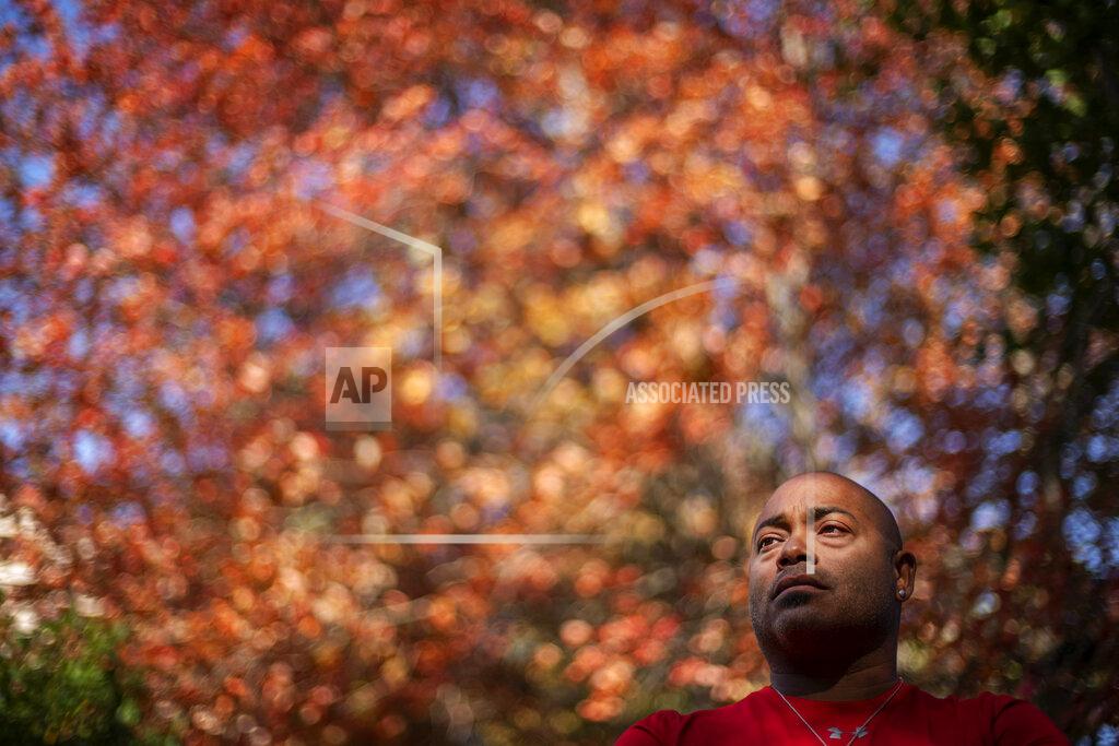 David Goldman Troy Currence, 48, a medicine man from the Herring Pond Wampanaoag Tribe, stands for a portrait outside his home in Bourne, Mass., Monday, Sept. 21, 2020. Currence says he's hopeful that the attention on the problem of systemic racism this year will help their voices and stories be heard in a way they haven't been before. "It's opening up everyone else's eyes to how unbalanced the world is and unequal," he said. The world is spinning out of control. So I think more people are going to be aware and more sensitive and open to receiving a message like that." (AP Photo/David Goldman)