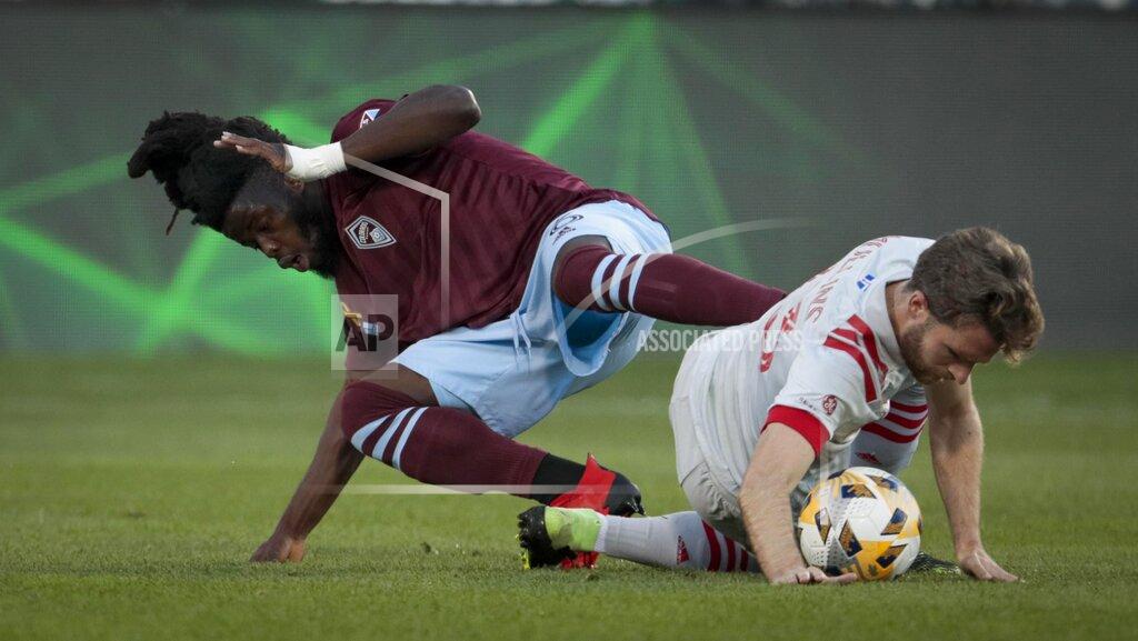 Joe Mahoney Colorado Rapids defender Lalas Abubakar, left, tangles with Toronto FC forward Patrick Mullins (13) for the ball in the first half of an MLS soccer game in Denver, Saturday, Sept. 25, 2021. (AP Photo/Joe Mahoney)