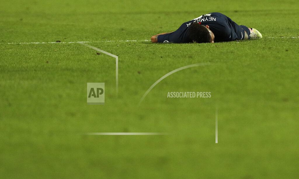 Miguel A. Lopes PSG's Neymar lies on the pitch during the Champions League final soccer match between Paris Saint-Germain and Bayern Munich at the Luz stadium in Lisbon, Portugal, Sunday, Aug. 23, 2020. (Miguel A. Lopes/Pool via AP)