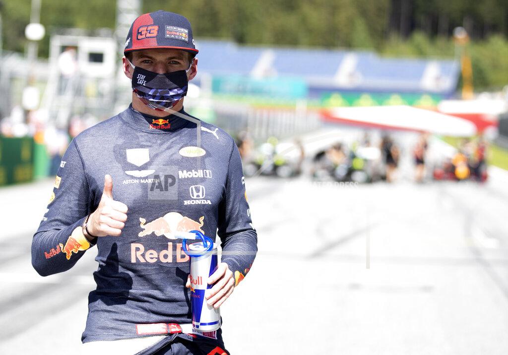 Red Bull driver Max Verstappen of the Netherlands, wearing a mask against the spread of the coronavirus, poses after he clocked the third fastest time during the qualifying session at the Red Bull Ring racetrack in Spielberg, Austria, Saturday, July 4, 2020. The Austrian Formula One Grand Prix will be held on Sunday. (Mark Thompson/Pool via AP)