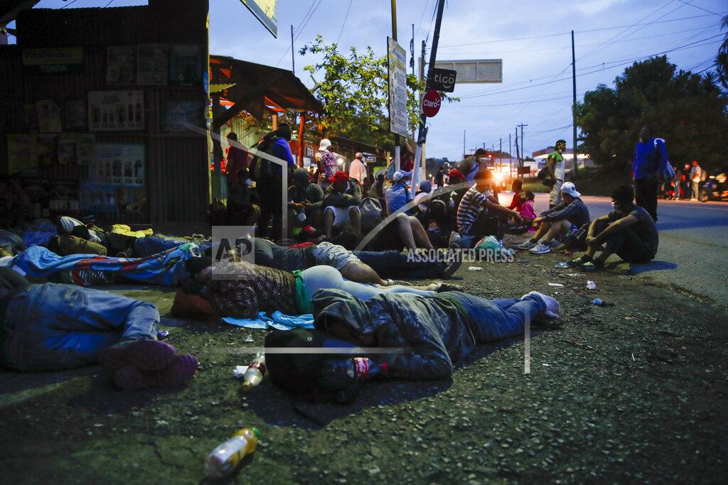 Moises Castillo Honduran migrants rest in Puerto Barrios, Guatemala, Friday, Oct. 2, 2020. About 2,000 Honduran migrants hoping to reach the United States entered Guatemala on foot Thursday, but Guatemalan President Alejandro Giammattei vowed to detain them and return them to their home country saying they represented a health threat amid efforts to contain the coronavirus pandemic. (AP Photo/Moises Castillo)