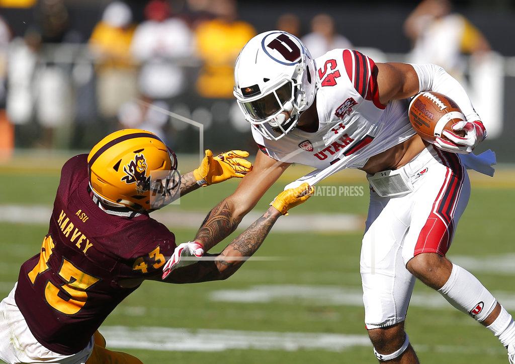 Rick Scuteri Arizona State safety Jalen Harvey (43) holds on for a tackle of Utah wide receiver Samson Nacua in the first half during an NCAA college football game, Saturday, Nov. 3, 2018, in Tempe, Ariz. (AP Photo/Rick Scuteri)