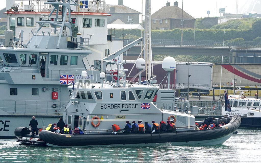 Gareth Fuller A group of people thought to be migrants are brought into port aboard a Border Force vessel, at Dover, England, Monday July 26, 2021. The group of people were picked up by the border force vessel following a small boat incident in the Channel. (Gareth Fuller/PA via AP)