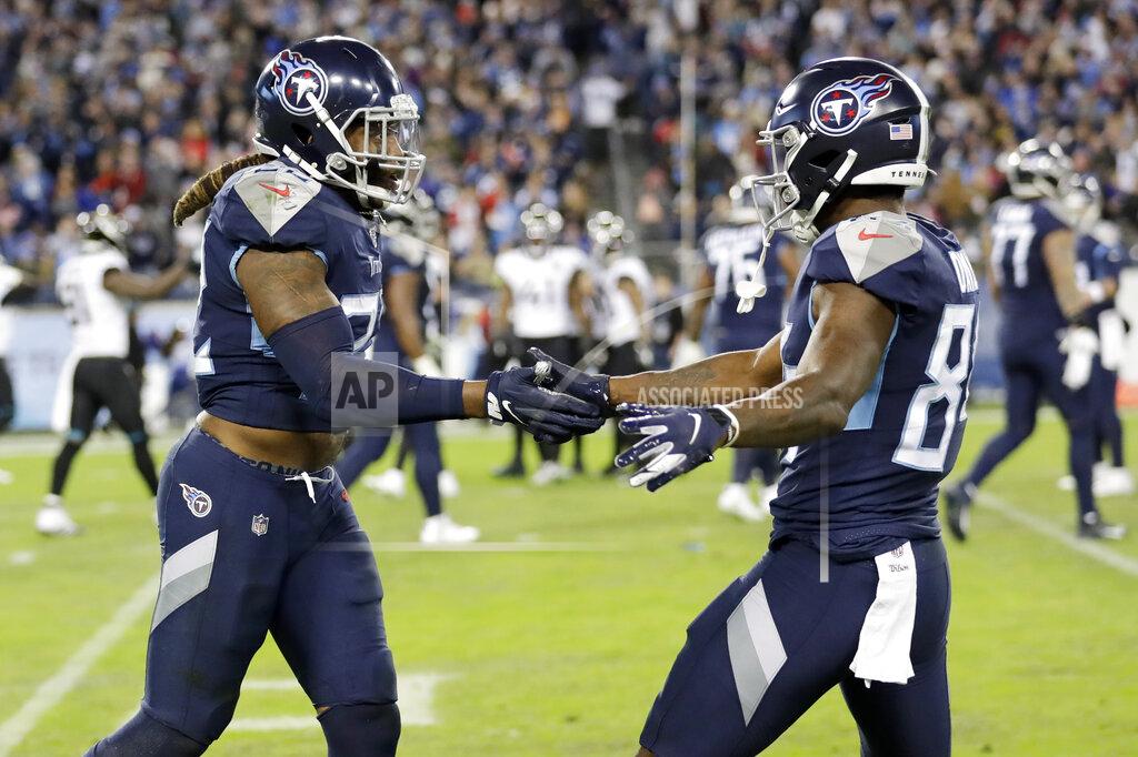 James Kenney Tennessee Titans running back Derrick Henry (22) is congratulated by wide receiver Corey Davis, right, after Henry scored a touchdown against the Jacksonville Jaguars in the second half of an NFL football game Sunday, Nov. 24, 2019, in Nashville, Tenn. (AP Photo/James Kenney)
