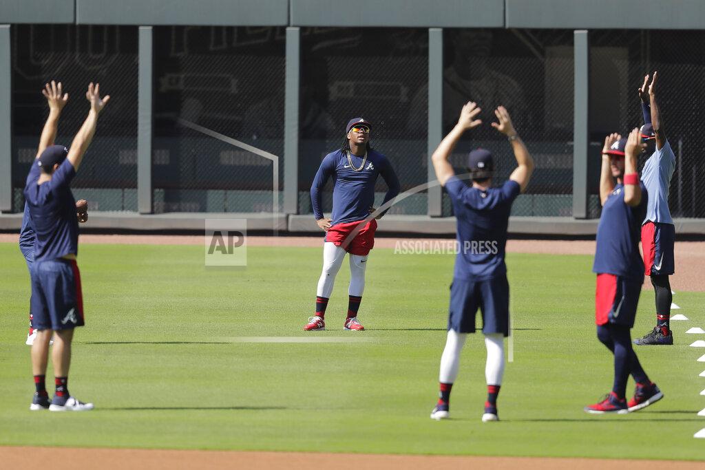 Brynn Anderson Atlanta Braves' Ronald Acuña Jr., center, stretches with teammates during team practice at Truist Park on Sunday, July 5, 2020, in Atlanta. (AP Photo/Brynn Anderson)