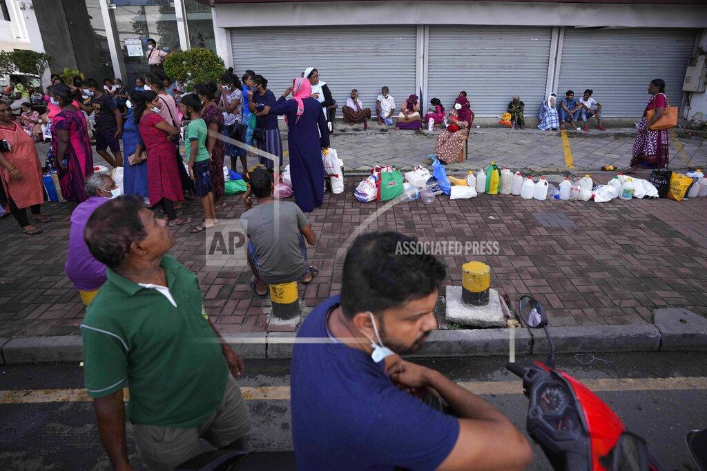 Eranga Jayawardena Sri Lankans stand in queues to buy fuel in Colombo, Sri Lanka, Thursday, May 26, 2022. Sri Lankans for months have been forced to stand in long lines to buy scarce essentials, with many returning home empty-handed. There is a severe shortage of many goods, from food, cooking gas, medicine and fuel to toilet paper and matchsticks.(AP Photo/Eranga Jayawardena)