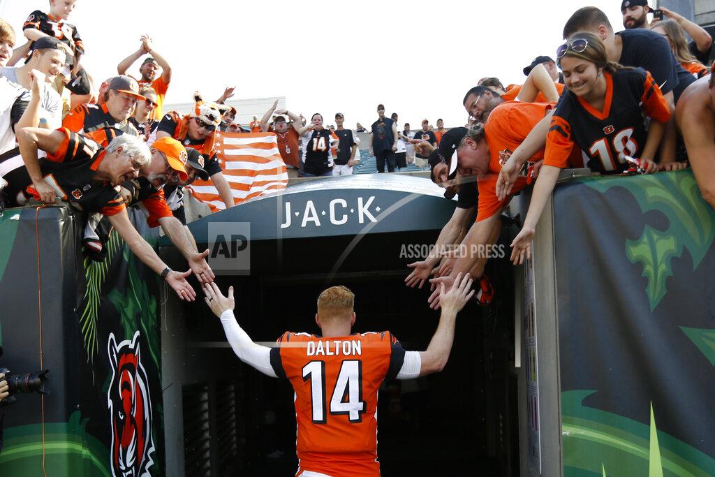 Frank Victores FILE - In this Oct. 7, 2018, file photo, Cincinnati Bengals quarterback Andy Dalton (14) high-fives fans as he leaves the field following an NFL football game against the Miami Dolphins in Cincinnati. The Bengals cleared the way for Joe Burrow to lead the team by releasing quarterback Andy Dalton, who holds several of the franchise's passing records but couldn't lead the woebegone Bengals deep into the playoffs. The move Thursday, April 30, 2020, gives Dalton, who had a year left on his deal, a chance to compete for a job with another team. (AP Photo/Frank Victores, File)