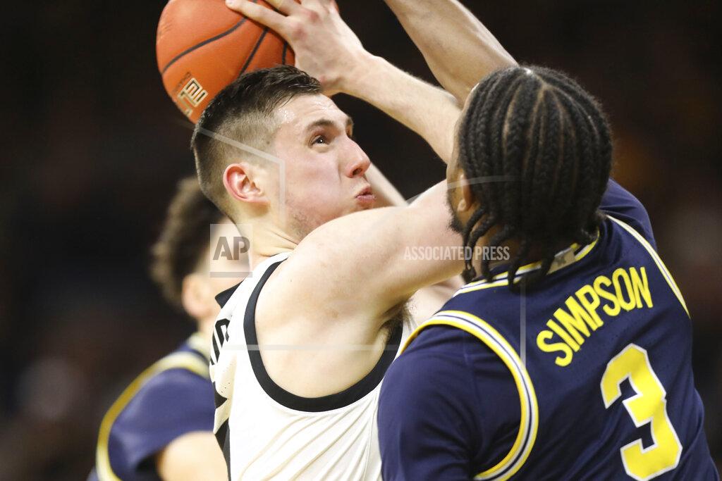 Rebecca F. Miller Iowa guard CJ Fredrick shoots while under pressure from Michigan guard Zavier Simpson (3) during the first half of an NCAA college basketball game Friday, Jan. 17, 2020, in Iowa City, Iowa. (Rebecca F. Miller/The Gazette via AP)