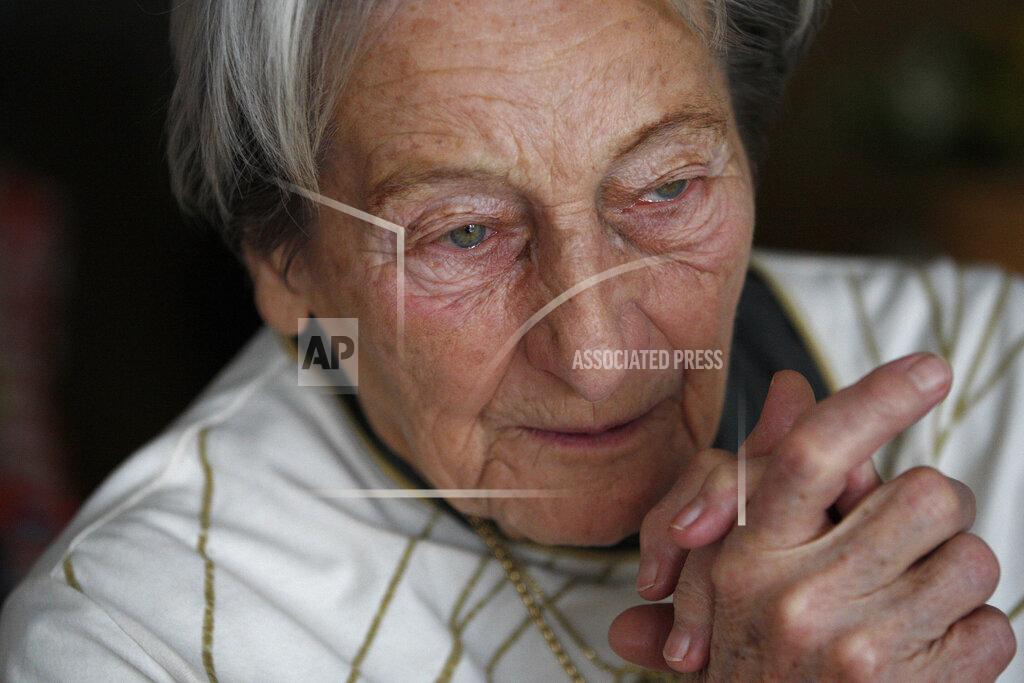 FILE - In this file photo taken March 15, 2012, the 1952 Helsinki Olympic javelin champion Dana Zatopkova speaks during an interview with The Associated Press in Prague, Czech Republic. Dana Zatopkova, the Olympic javelin champion and the wife of late athletics great Emil Zatopek has died, aged 97, the Czech Olympic Committee said Friday March 13, 2020. (AP Photo/Petr David Josek, FILE)